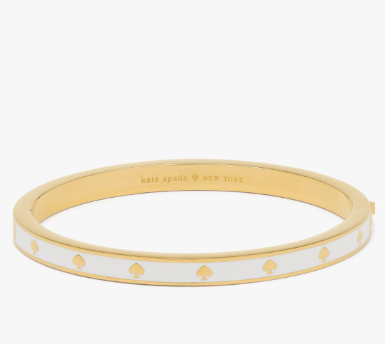 Pulera Kate Spade blanca con dorado