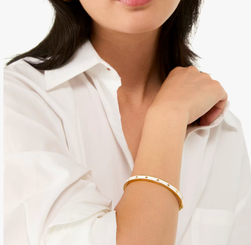 Pulera Kate Spade blanca con dorado