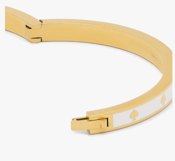 Pulera Kate Spade blanca con dorado