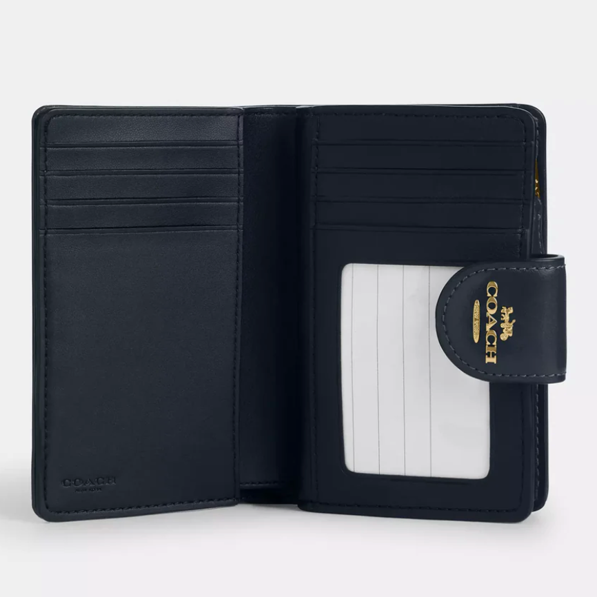 Billetera Coach mediana de tela monograma azul marino